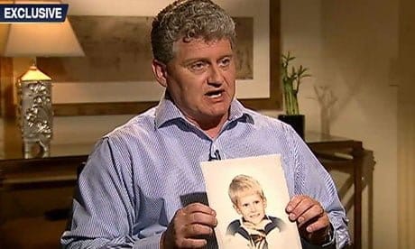 Lonnie Snowden holding up a picture of Edward Snowden